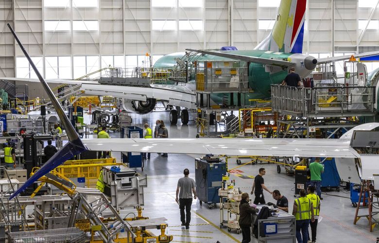 Boeing employees work on the 737 MAX on the final assembly line at Boeing’s Renton plant Wednesday, June 15, 2022. 220682