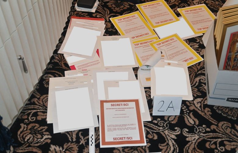 An image the Department of Justice included in an August 30, 2022 court filing shows documents marked SECRET//SCI that were recovered from Donald Trump’s Mar-a-Lago club and home in Florida. Among the new disclosures in the 36-page filing were that the search yielded three classified documents in desks inside Trump’s office, with more than 100 documents in 13 boxes or containers with classification markings in the residence, including some at the most restrictive levels. (Department of Justice via The New York Times) – FOR EDITORIAL USE ONLY – XNYT6 XNYT6