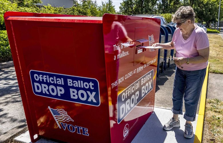Jane Cahilig, of Battle Ground, drops off a ballot during the Primary at the United States Post Office in Battle Ground, Wash., on Tuesday Aug. 2, 2022.