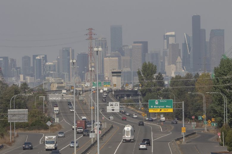 Cars cruise over the First Avenue bridge Wednesday in front of a  hazy Seattle skyline. (Ellen M. Banner / The Seattle Times)
