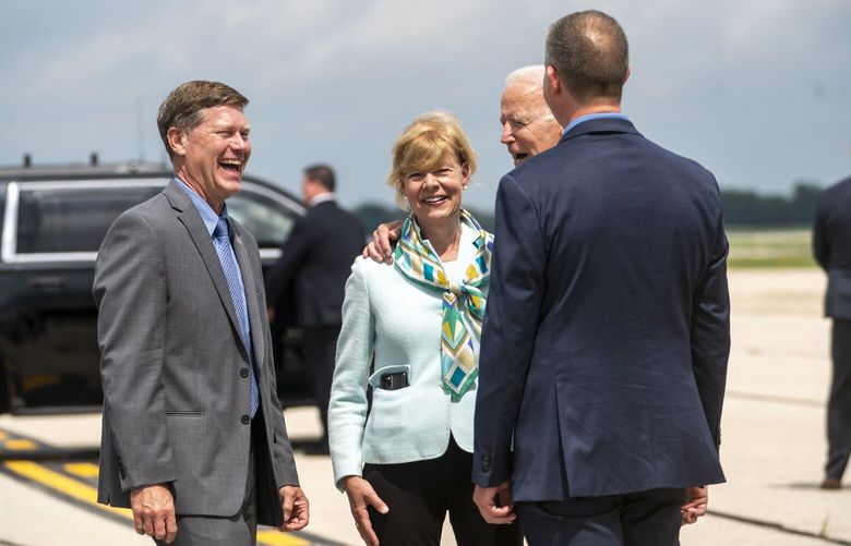 FILE — President Joe Biden is greeted by Sen. Tammy Baldwin (D-Wis.), center, Rep. Ron Kind (D-Wis.), left, and Mitch Reynolds, Mayor of La Crosse, at the La Crosse Regional Airport in La Crosse, Wis., on June 29, 2021. Democrats are defending more than a dozen seats in which the incumbent has said they will not run for re-election, complicating their effort to stop Republicans from reclaiming the House majority. (Doug Mills/The New York Times) XNYT128 XNYT128