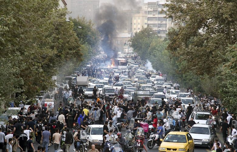 FILE – In this photo taken by an individual not employed by the Associated Press and obtained by the AP outside Iran, protesters chant slogans during a protest over the death of a woman who was detained by the morality police, in downtown Tehran, Iran, Sept. 21, 2022.  (AP Photo, File) WX304 WX304