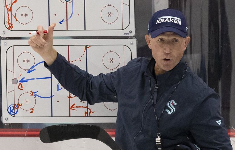 Seattle Kraken ice hockey coach Dave Hakstol talks to players during the first day of training camp at the Kraken Community Iceplex in Seattle, WA on September 22, 2022. 221587