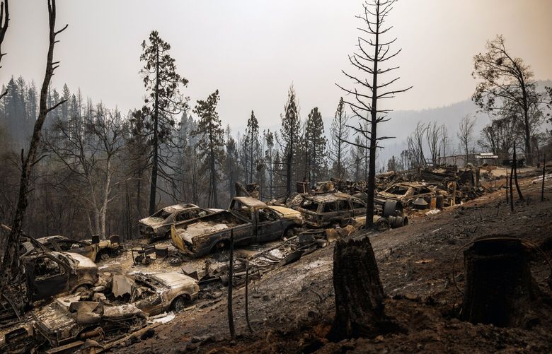 FILE – A pall of smoke hangs over the charred wreckage of cars burned in the Mosquito Fire in Michigan Bluff, Calif., on Sept. 10, 2022. Smoke from wildfires has worsened over the past decade, potentially reversing decades of improvements in Western air quality made under the Clean Air Act, according to research published by Stanford University on Thursday, Sept. 22, 2022. (Max Whittaker/The New York Times) XNYT132 XNYT132