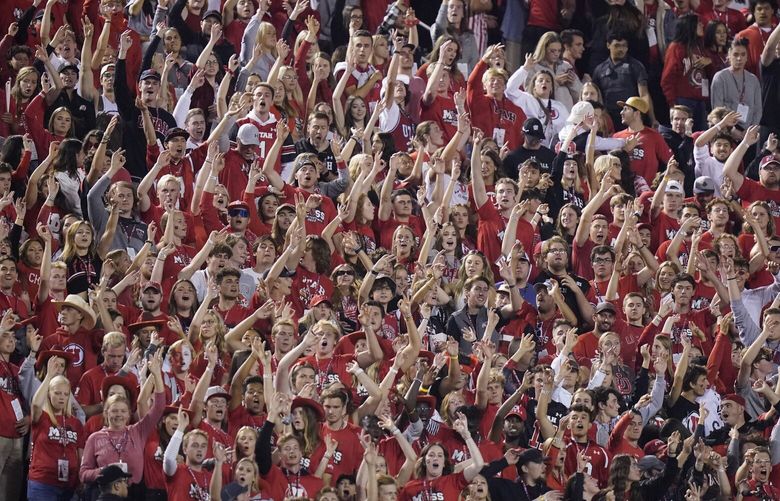 The Utah student section show their support during the first half of an NCAA college football game against San Diego State and Utah Saturday, Sept. 17, 2022, in Salt Lake City. A University of Utah student was arrested on suspicion of making terrorist threats after police said she threatened to detonate a nuclear reactor if the school’s football team failed to win a game last Saturday. Charging documents filed in Salt Lake City on Wednesday, Sept. 21, 2022 allege that the student posted threats before Utah’s game against San Diego State University on Saturday. (AP Photo/Rick Bowmer) UTRB101 UTRB101