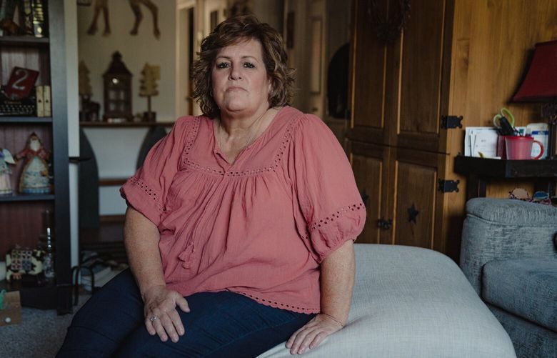 Bev Kolpin, 57, a former sonogram technician at a Providence hospital who was billed $8,000 for a surgery despite being eligible for discounted rates, at home in Gresham, Ore. on Aug. 12, 2022. With the help of a consulting firm, one of the country’s largest nonprofit hospital chains trained staff to wring money out of patients, even those eligible for free care. “I had worked for them and given them so much, and they didn’t give me anything,” Kolpin said. (Jovelle Tamayo/The New York Times) XNYT12 XNYT12