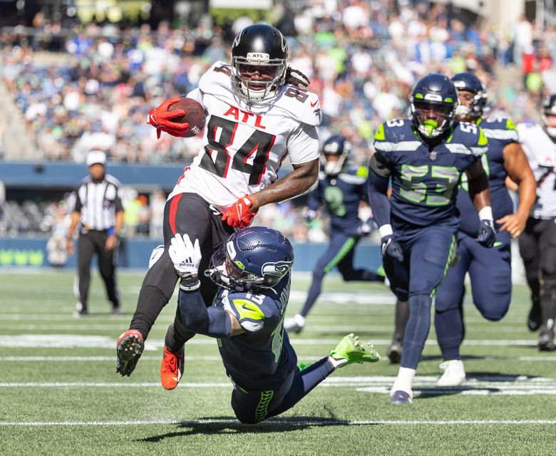 Josh Jones has Atlanta’s Cordarrelle Patterson by the knees, but Patterson drags him into the end zone on a 17-yard touchdown in the second quarter. (Dean Rutz / The Seattle Times)