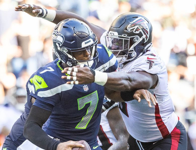 One play after the Seahawks get the ball back via fumble in the fourth quarter, Geno Smith gives up an 8-yard sack to Lorenzo Carter. (Dean Rutz / The Seattle Times)