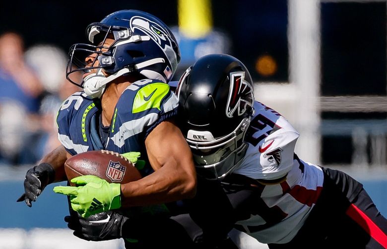 Seattle Seahawks wide receiver Tyler Lockett absorbs a hit from Atlanta Falcons cornerback Casey Hayward during the second quarter, Sunday, Sept. 25, 2022, in Seattle. 221653