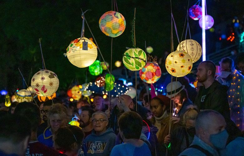 People walk in the Luminata parade around Green Lake on Saturday, Sept. 24. Luminata is an annual lantern festival celebrating the autumnal equinox and organized by the Fremont Arts Council, held this year on Saturday, Sept. 24.