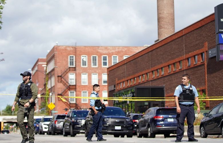 Officers set up crime tape outside a Chicago Police Department building in Homan Square, in Chicago, Monday, Sept. 26, 2022, where a person was shot by police. Chicago’s police chief says a man used a fire escape Â to infiltrate a police facility where officers were undergoing a SWAT training exercise and grabbed at least two guns before he was shot and wounded by police. (Anthony Vazquez/Chicago Sun-Times via AP) ILCHS401 ILCHS401