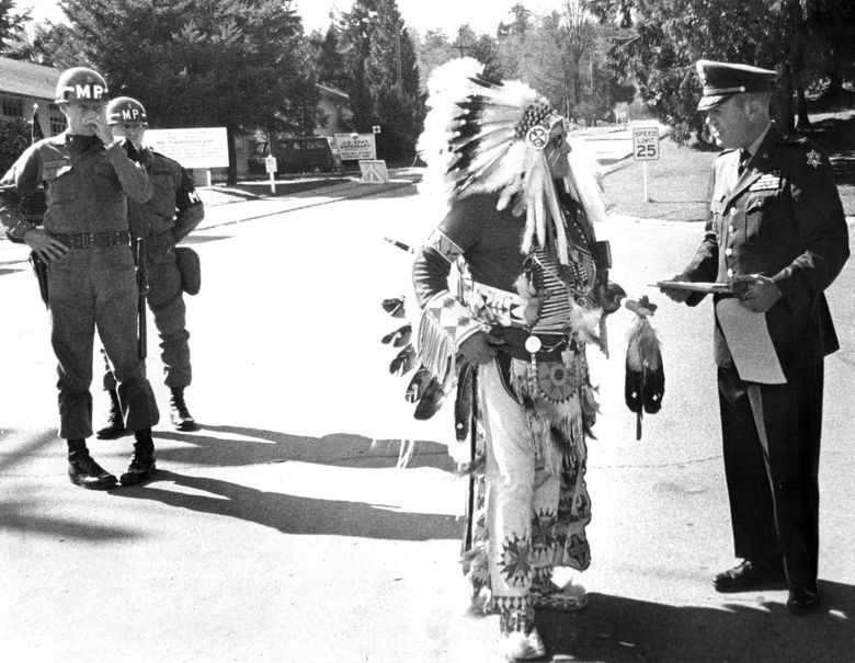 March 19, 1970: &#8220;Chief confers title on Lawton commander &#8212; Chief White Buffalo Man, grandson of Sitting Bull, yesterday gave Fort Lawton&#8217;s commander, Col. Stuart J. Palos, a new title: Kangee-Saihe, or Crow Foot. Military policemen looked on. Palos received the honorary title after inviting the chief inside the fort, a privilege denied other Indians who are demonstrating to dramatize their demand that part of the fort be given to the Indians. The demonstration yesterday included a &#8216;message&#8217; in the sky.&#8221; (Ron De Rosa / The Seattle Times)