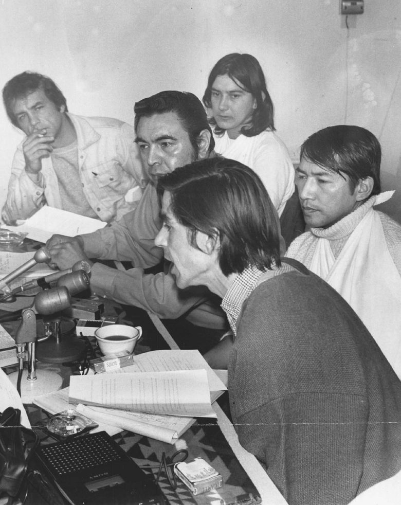 March 9, 1970: &#8220;John Vigil, foreground, a Pueblo Indian from Algodones, N.M., spoke today during a news conference concerning the &#8216;invasions&#8217; yesterday of Fort Lawton and Fort Lewis. Indian leaders said they plan a demonstration tomorrow at the United States Courthouse and will picket Fort Lawton. Seated nearest the table, from left: Gary Bray, of Colville; Robert Satiacum, chief of the Puyallup tribe; and Vigil. At rear were Sid Mills, a Yakima Indian of Nisqually, Thurston County, and Bernie Whitebear, a Colville Indian of Seattle. Mills and Whitebear said they were injured at Fort Lawton yesterday.&#8221; (George Carkonen / The Seattle Times)