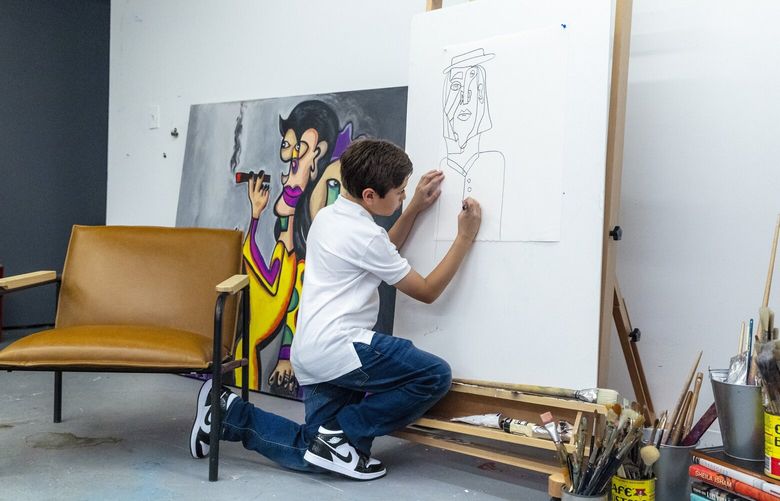 Andres Valencia sketches a piece in a basement studio of the Chase Contemporary Gallery in the SoHo neighborhood of New York, where his art was exhibited this summer, Aug. 1, 2022. Valencia’s paintings have sold for more than $125,000 – and he’s 10 years old. (Elliott Jerome Brown Jr./The New York Times) XNYT130 XNYT130