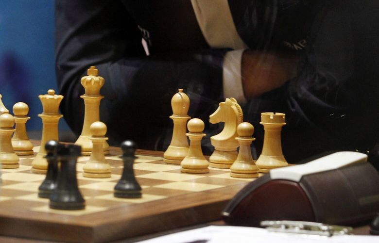 Norway’s Magnus Carlsen plays chess during the Chess World Championship match in Chennai, India, Friday, Nov. 22, 2013. (AP Photo/Arun Sankar K.)