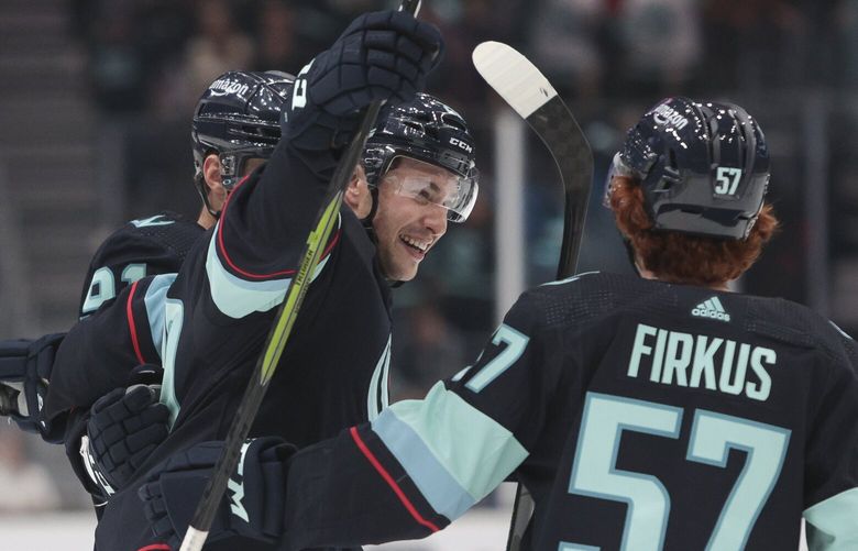 Seattle Kraken’s Daniel Sprong, Vince Dunn and Jagger Firkus, from left, celebrate after Sprong’s goal against the Calgary Flames during the second period of a preseason NHL hockey game Tuesday, Sept. 27, 2022, in Seattle. (AP Photo/Jason Redmond) WAJR106 WAJR106
