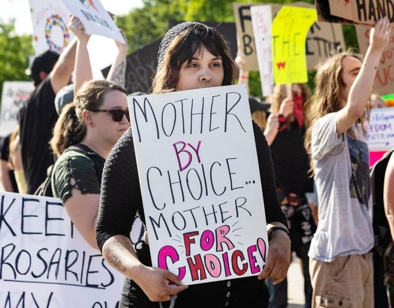 Jessica Kampula, a mother of an adopted child, came to counterprotest those who were celebrating the overturning of Roe v. Wade in Boise. (Sarah A. Miller / TNS)