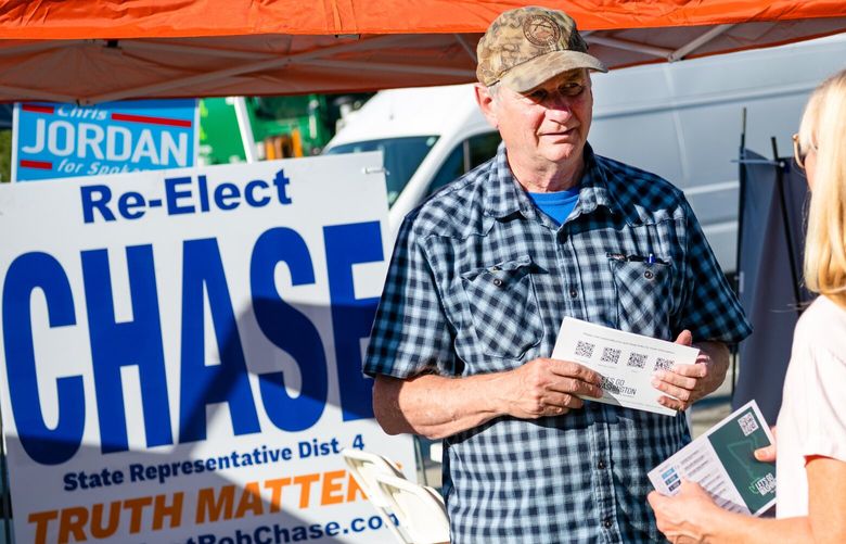 Rob Chase, running for re-election to the Washington House of Representatives, greets constituents at his booth at Valleyfest, a community event in Spokane Valley on Sept. 24.