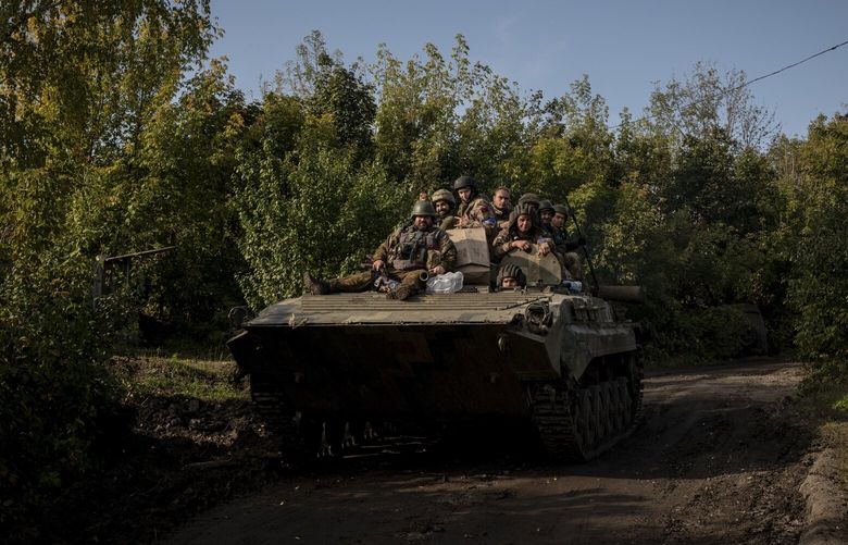 Ukrainian soldiers ride atop a military vehicle near Kupiansk, Ukraine toward the front line on Friday, Sept. 30, 2022. The Ukrainian military has pushed Russian forces further southeast of the Oskil River as they continue their counter-offensive in the Kharkiv region. (Nicole Tung/The New York Times) XNYT204 XNYT204