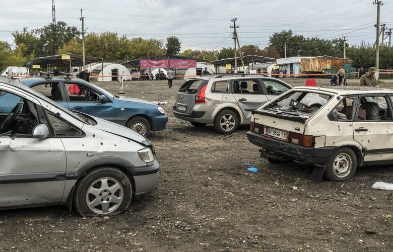 Damaged cars are still lined up at the scene of a Russian missile strike at a checkpoint on the edge of Zaporizhzhia, Ukraine on Friday, Sept. 30, 2022. The attack killed at least 25 civilians who were waiting at a checkpoint and bus stop, and injured about 50, according to Ukraineâ€™s prosecutor general â€” which would make it one of the deadliest single attacks against civilians in recent weeks. (Brendan Hoffman/The New York Times) XNYT5 XNYT5