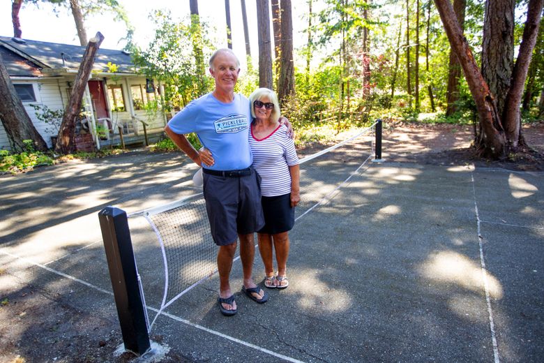 Scott and Carol Stover live on the property where the first pickleball court was created in 1965. The court, shown here, is crumbling but still usable.  (Mike Siegel / The Seattle Times)