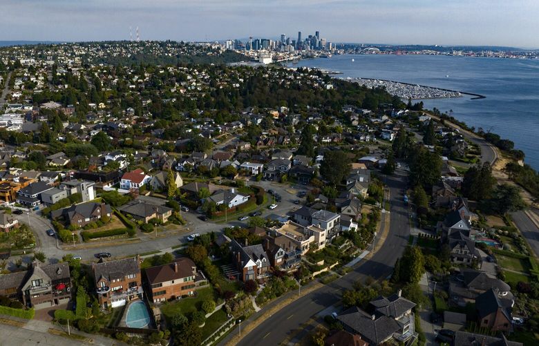 Magnolia homes are seen from the air with downtown Seattle off in the distance, Wednesday, Sept. 21, 2022.