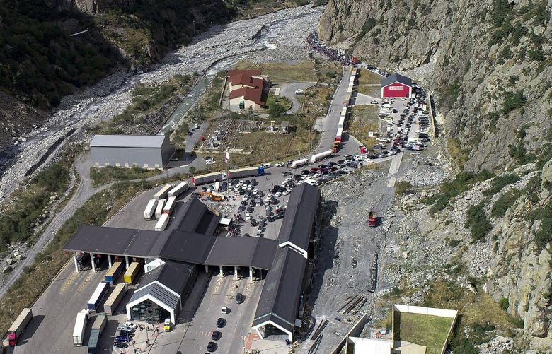 An aerial view of the border crossing at Verkhny Lars between Georgia, bottom, and Russia, in Georgia, Wednesday, Sept. 28, 2022. Long lines of vehicles have formed at a border crossing between Russia’s North Ossetia region and Georgia after Moscow announced a partial military mobilization. A day after President Vladimir Putin ordered a partial mobilization to bolster his troops in Ukraine, many Russians are leaving their homes. (AP Photo/Zurab Tsertsvadze) XAZ111 XAZ111