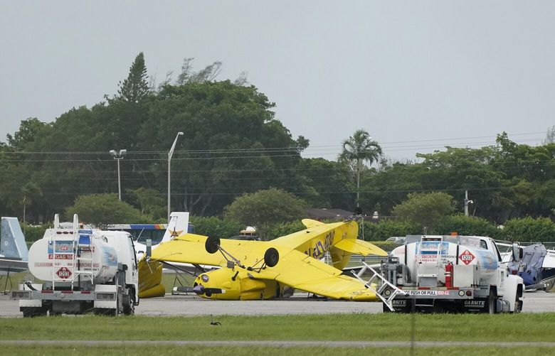An airplane overturned by a likely tornado produced by the outer bands of Hurricane Ian is shown, Wednesday, Sept. 28, 2022, at North Perry Airport in Pembroke Pines, Fla. Hurricane Ian rapidly intensified as it neared landfall along Florida’s southwest coast Wednesday morning, gaining top winds of 155 mph (250 kph), just shy of the most dangerous Category 5 status. (AP Photo/Wilfredo Lee) FLWL103