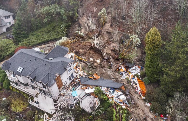 Tuesday, Januarey 18, 2022.   A drone look at the hillside and landslide area where a Bellevue Home slid off itâ€™s foundation from a water main break.  Forest Ridge School’s parking lot is right above the home.  219358