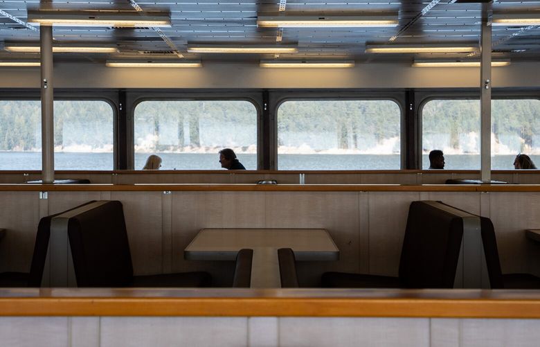 Passengers chat in the passenger cabin of the M.V. Yakima, operated by Washington State Ferries, on Monday, Sept. 5, 2022.