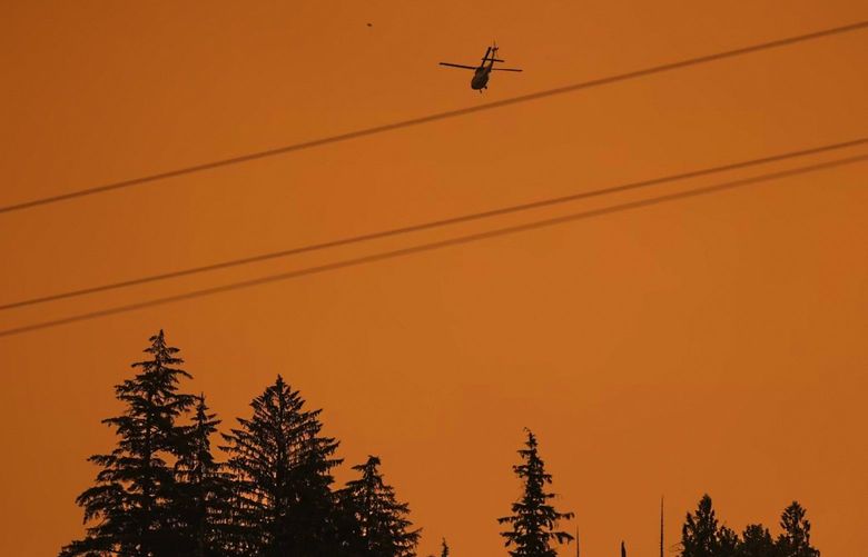 A helicopter works the scene of the Bolt Creek Fire near Index Saturday September 10, 2022.