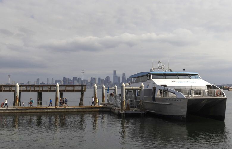 Passengers disembark from the King County Water Taxi named Doc Maynard at Seacrest Dock in West Seattle Tuesday, September 13, 2022.  The taxi operates year-round.  It began in 1998 to lesson congestion on the West Seattle Bridge and today more than 100,000 people travel on it annually.  In the summer months, approximately 1,000 people ride on it daily, according to highpointseattle.com.  Crossing time is 12 minutes and passengers can get on the taxi at the foot of Spring Street along Seattle‚Äôs waterfront. 221566