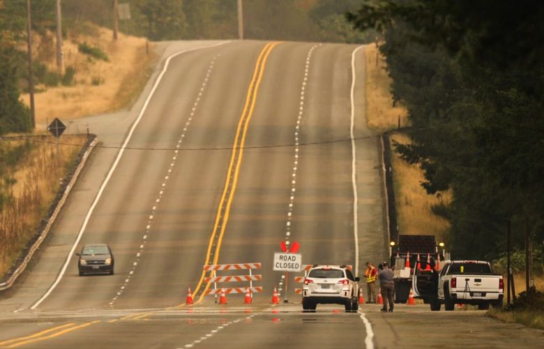 A roadblock closes Highway 2 west of Gold Bar due to the rapidly-growing Bolt Creek Fire Saturday September 10, 2022.