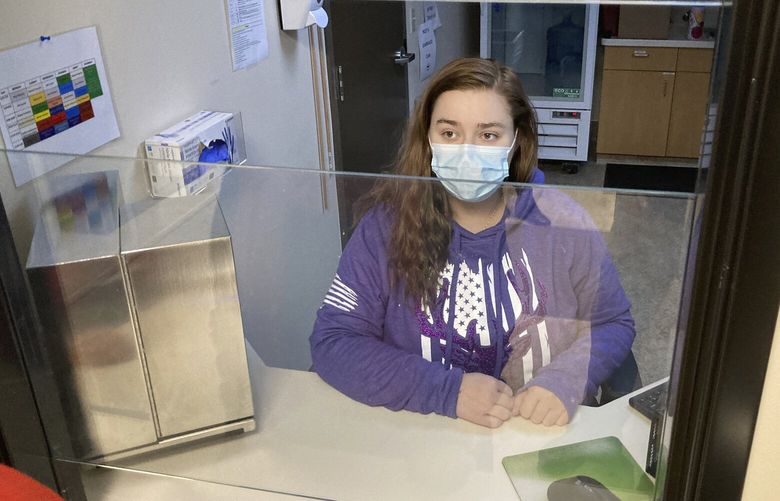 FILE—Vanessa Caudel, a nurse, sits at her work station in the Great Circle treatment center on Feb. 24, 2022, in Salem, Ore., where she provides doses of methadone, which can relieve the “dope sick” symptoms a person in opioid withdrawal experiences. Almost two years after Oregonians voted to decriminalize drugs and dedicate hundreds of millions of dollars to treatment services, the pioneering effort has been struggling to show progress. (AP Photo/Andrew Selsky, File) RPOR701 RPOR701
