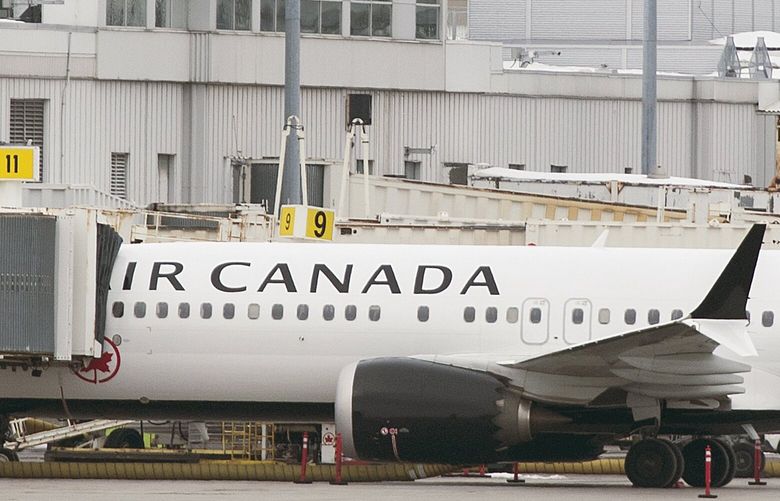 An Air Canada Boeing 737 Max 8 aircraft is parked next to a gate at Trudeau Airport in Montreal, Wednesday, March 13, 2019. Canada’s transport minister says the country is closing air space to the Boeing 737 Max 8 jet following the crash of an Ethiopian Airlines jetliner. (Graham Hughes/The Canadian Press via AP) GMH101 GMH101 GMH101