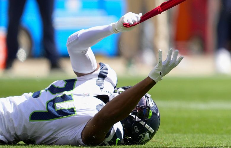 San Francisco 49ers wide receiver Ray-Ray McCloud III (3) runs as Seattle Seahawks cornerback Isaiah Dunn (24) grabs his jersey during the first half of an NFL football game in Santa Clara, Calif., Sunday, Sept. 18, 2022. (AP Photo/Tony Avelar) FXN118 FXN118