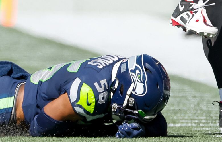 Seattle Seahawks linebacker Jordyn Brooks goes facedown in the turf as he attempts to tackle down Atlanta Falcons quarterback Marcus Mariota during the second quarter, Sunday, Sept. 25, 2022, in Seattle. 221653