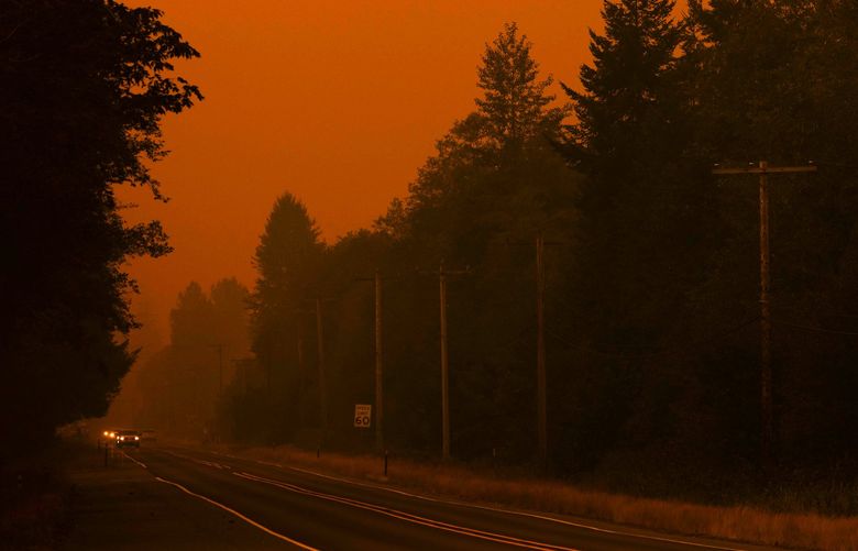 Orange smoke engulfs Highway 2 in Baring on Saturday on Sept. 10, 2022.