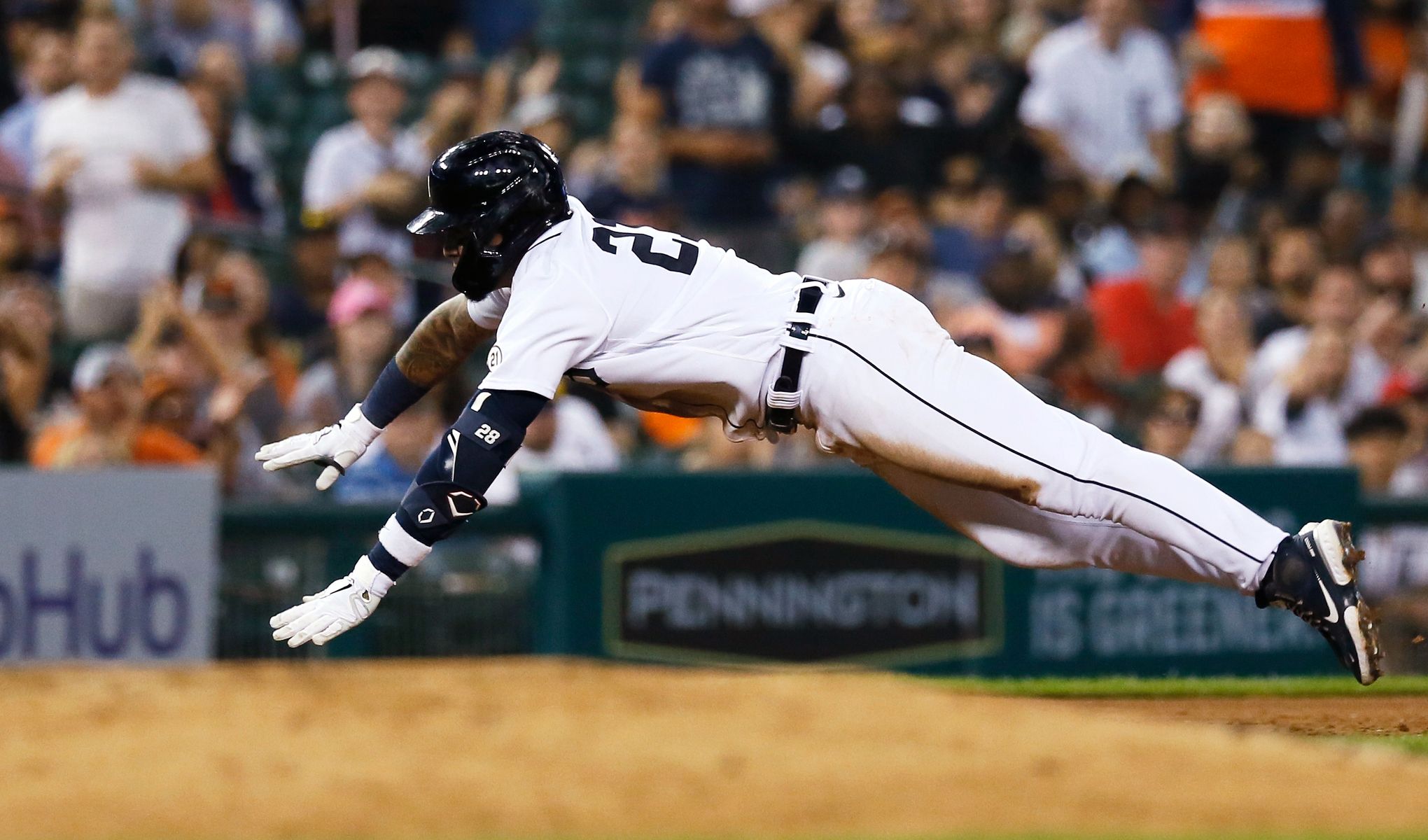 Detroit Tigers shortstop Javier Baez (28) throws a ball to fans