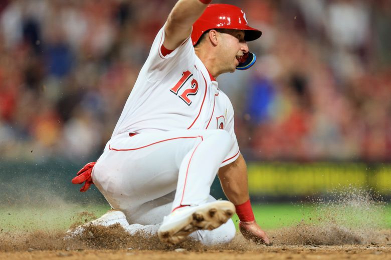 Cincinnati Reds' Jonathan India, left, receives the Major League