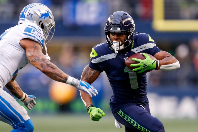 Seattle Seahawks wide receiver Dee Eskridge (1) jogs on the field