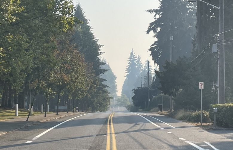 A progressively hazier horizon is visible looking east on NE 150th St. in Shoreline Wednesday. Wildfire smoke from the Bolt Creek fire has once again infiltrated the Seattle area.