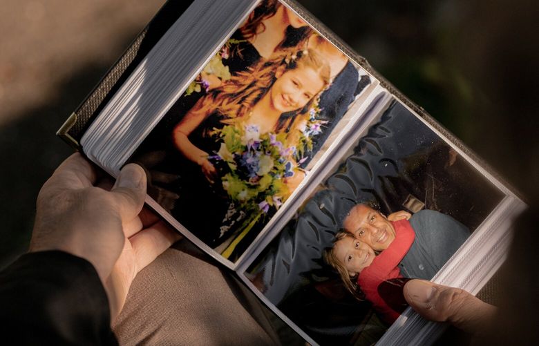 Ian Russell holds a photo album of his daughter Molly Russell, a teenager who died by suicide in November 2017, near his home in Harrow, in northwest London, Sept. 17, 2022. The coroner overseeing the case in Britain ruled that Instagram and other social media platforms had contributed to her death – perhaps the first time anywhere that internet companies have been legally blamed for a suicide. (Jonathan Clifford/The New York Times)
