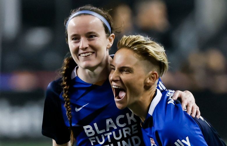 OL Reign midfielder Jess Fishlock, right, celebrates with midfielder Rose Lavelle after a 3-0 win over the Orlando Pride. 221717