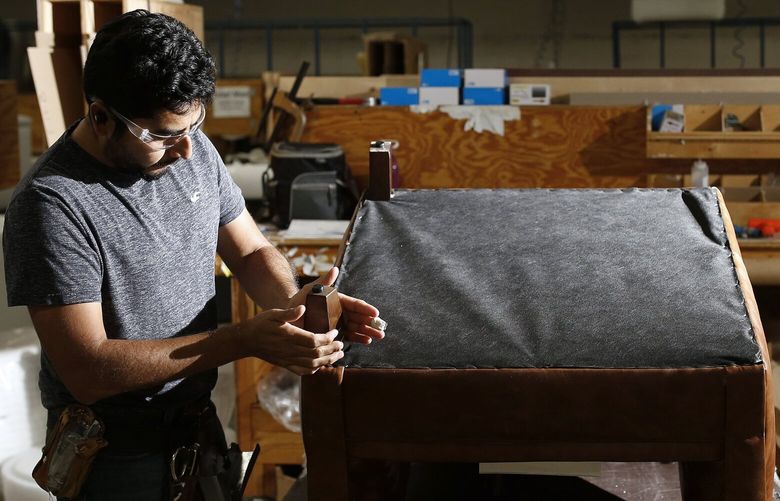 Omar Alvarez works on a piece of furniture at a Klaussner Home Furnishings manufacturing campus in Asheboro, N.C., Oct. 3, 2022. Unemployment is low, and hiring is strong – but there are signs that frenzied turnover and rapid wage growth are abating. (Eamon Queeney/The New York Times) XNYT82