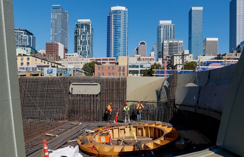 The Seattle skyline is seen to the west of the construction site of the new Ocean Pavilion, Tuesday, Sept. 20, 2022, in Seattle. The Oculus in the center will be a defining feature of the new pavilion and highlight the Coral Canyon which will be seen through the structure.  221584
