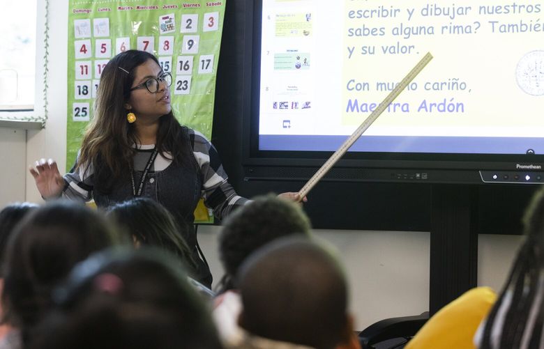 Fatima Nunez Ardon, a teacher in training, teaches Spanish to second graders at Madrona Elementary School in SeaTac Wednesday, September 28, 2022.

Fatima went through a program at Highline College, a community college, to train to be a teacher. Having teachers do their coursework at a community college is relatively new and Washington is one of only a handful of states that allows it. The idea is to diversify the teacher workforce (community colleges serve more students of color), and train up more teachers. Fatima is working in the class as part of the program to finish her degree.

 221697