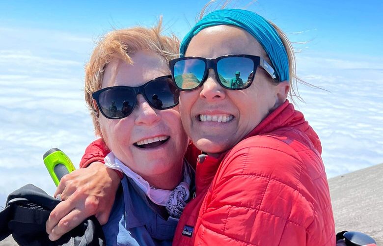 Barbara Travers, left, and Team Survivor NW team leader Abbe Jacobson celebrate upon reaching the summit of Mount St. Helens Aug. 10, 2022. (Courtesy of Team Survivor Northwest Photo)