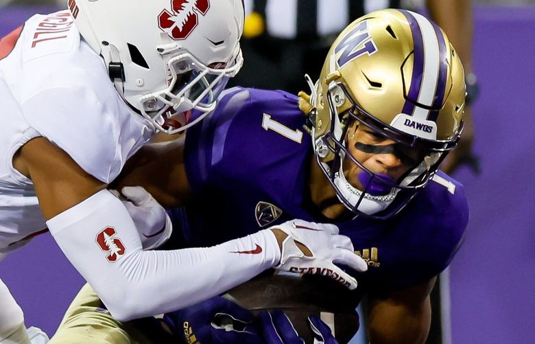 Washington Huskies wide receiver Rome Odunze tucks away a 30-yard touchdown reception despite the coverage by Stanford Cardinal safety Jonathan McGill during the third quarter, Saturday, Sept. 24, 2022, in Seattle. 221629