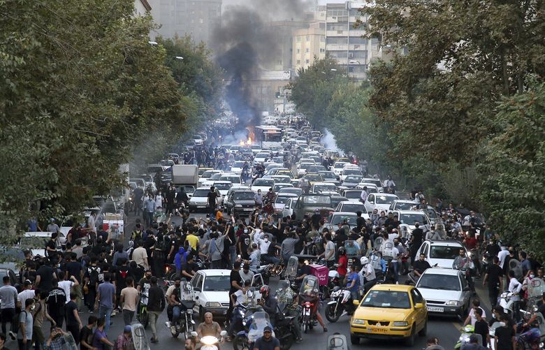 In this Wednesday, Sept. 21, 2022, photo taken by an individual not employed by the Associated Press and obtained by the AP outside Iran, protesters chant slogans during a protest over the death of a woman who was detained by the morality police, in downtown Tehran, Iran. Iranians saw their access to Instagram, one of the few Western social media platforms still available in the country, disrupted on Wednesday following days of the mass protests. (AP Photo) NY101 NY101